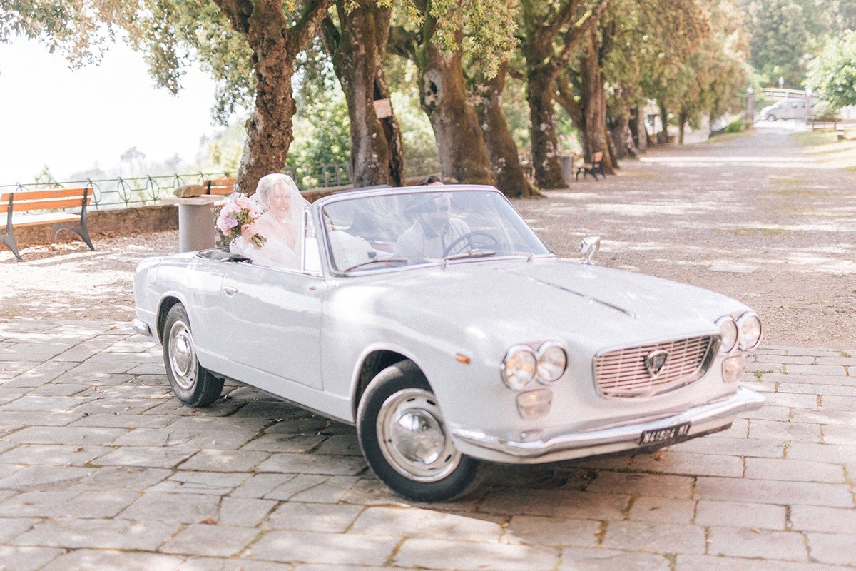 white vintage convertible car outside the sanctuary of soviore
